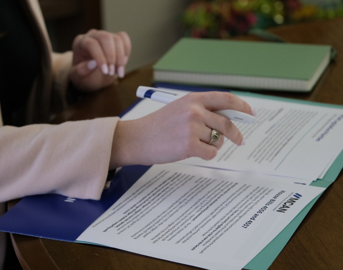 A person looking at MCAN documents