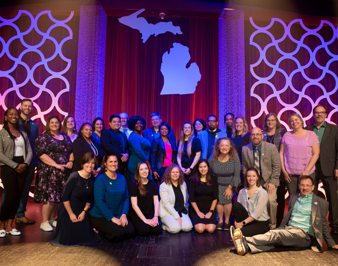 MCAN staff standing together on stage