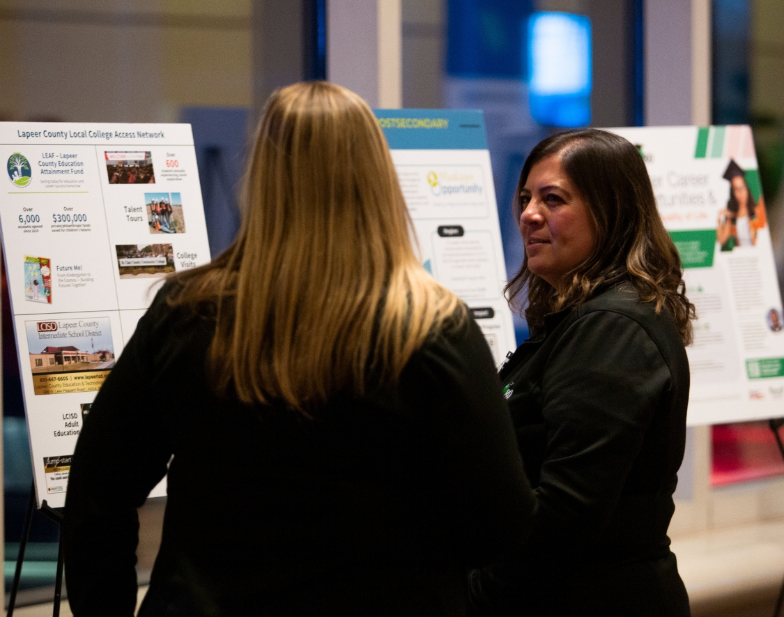 Two people looking at poster presentations